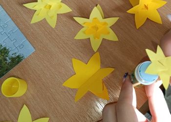 Powiększ zdjęcie: Uczniowie wykonują żonkile z papieru.